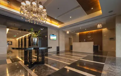a lobby with a table and a chandelier at Stunning 1 Bedroom Apartment in Dubai Marina in Dubai