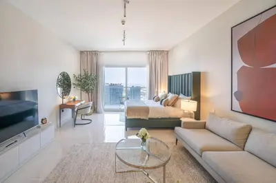 a large living room with a bed and a couch at Stunning High Floor Studio Apartment in BusinessBay in Dubai