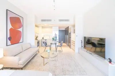 a living room with a couch and a table at Stunning High Floor Studio Apartment in BusinessBay in Dubai