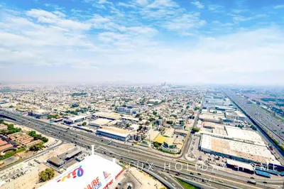 an overhead view of a city with traffic on a highway at LUX The Aykon Suite in Dubai