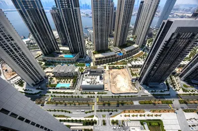 an aerial view of a city with tall buildings at Chic 2BD in Dubai Creek Harbour with Infinity Pool in Dubai
