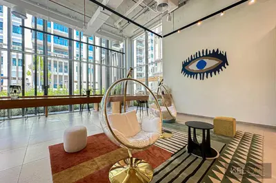 a lobby with a chair and an eye on the wall at WelHome - Fancy 1BR Apt at Dubai Hills near Dubai Hills Mall in Dubai