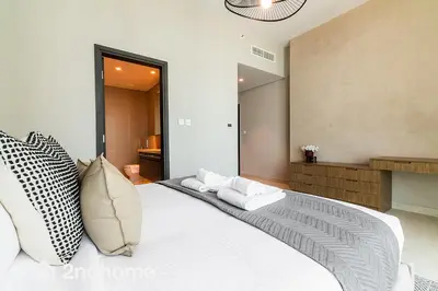 a bedroom with a large white bed with pillows at 2ndHome - Downtown Views 1 in Dubai
