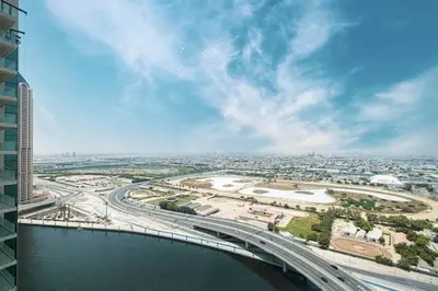 an overhead view of a bridge over a river at Luxury 1-BR with Lake View in Business Bay in Dubai