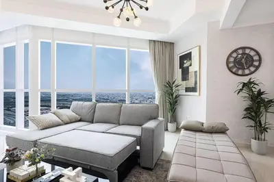 a living room with a couch and a large window at Luxury 1-BR with Lake View in Business Bay in Dubai