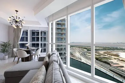 a large living room with a large window at Luxury 1-BR with Lake View in Business Bay in Dubai