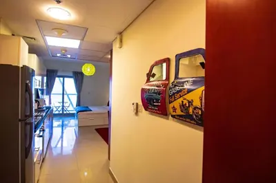 a hallway with paintings of a truck on the wall at Cozy Studio Apartment in DIFC in Dubai