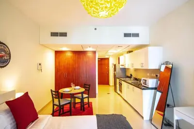 a room with a kitchen and a table in a room at Cozy Studio Apartment in DIFC in Dubai