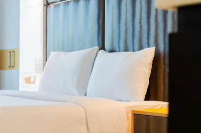 a bed with white pillows in a room with a window at Canal View l Hotel Studio l Great Amenities in Dubai