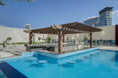 a swimming pool with a gazebo next to a swimming pool at Canal View l Hotel Studio l Great Amenities in Dubai