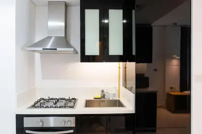 a kitchen with a stove top and a sink at Canal View l Hotel Studio l Great Amenities in Dubai