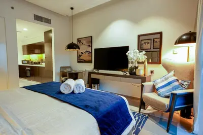 a bedroom with a bed and a desk and a chair at Majestine business bay in Dubai