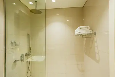 a bathroom with a shower and a sink and a towel at Majestine business bay in Dubai