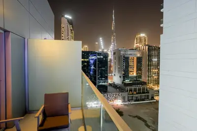 a room with a view of a city at night at Majestine business bay in Dubai
