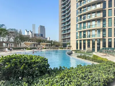 a large swimming pool in a city with tall buildings at Iconic Burj View 1BR in Burj Vista Tower Near Shops & Metro in Dubai