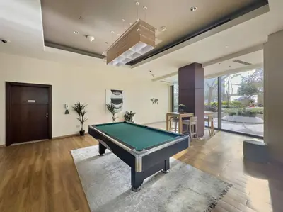 a living room with a pool table in it at Iconic Burj View 1BR in Burj Vista Tower Near Shops & Metro in Dubai