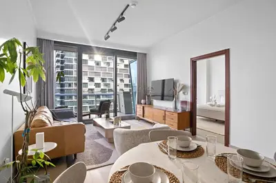 a living room with a couch and a table at Iconic Burj View 1BR in Burj Vista Tower Near Shops & Metro in Dubai