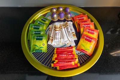 a yellow plate with some candy on a table at New Ultimate Stay 5 min walk from Dubai Mall Lofts Tower 5 pax in Dubai