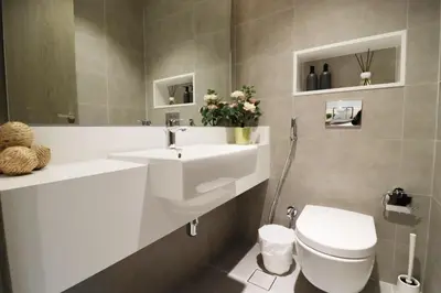 a bathroom with a white sink and a toilet at Stellar Dreams 1BR - District 1 in Dubai