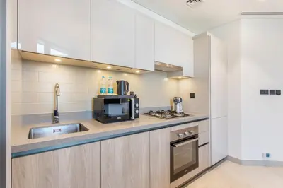 a kitchen with a sink and a microwave at STAY BY LATINEM Luxury 2BR Holiday Home W204 near Burj Khalifa in Dubai