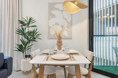 a dining room with a white table and chairs at STAY BY LATINEM Luxury 2BR Holiday Home W204 near Burj Khalifa in Dubai