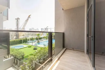 an apartment balcony with a view of the city at Modern Studio with Pool View & Gym Access in Dubai