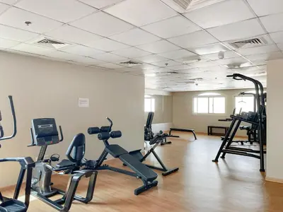 a gym with several exercise bikes in a room at New Studio in Sport City - Pool, Gym, Parking in Dubai
