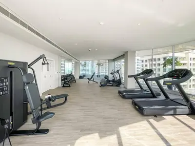 a gym with treadmills and ellipticals in a building at FIRST CLASS Studio Luxe Serenity Retreat in Dubai
