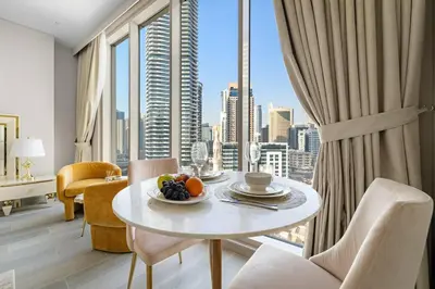 a dining room with a table and a large window at FIRST CLASS Studio Luxe Serenity Retreat in Dubai