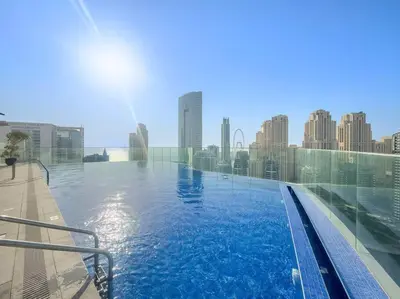 a swimming pool with a city skyline in the background at Marina-View 1BR Escape Walk to Dining & Landmarks in Dubai