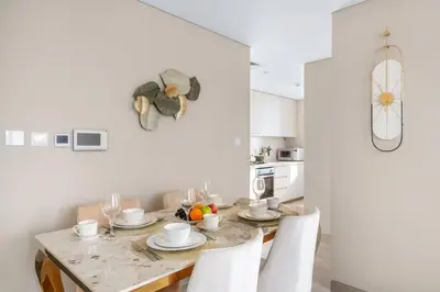 a dining room with a table and chairs in a kitchen at Marina-View 1BR Escape Walk to Dining & Landmarks in Dubai