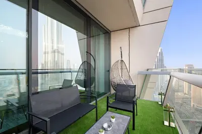 a room with two chairs and a table in a building at Luxury 4BR Flat, Downtown Dubai, Pool, Gym, PS5, Sleeps 11 Guests in Dubai