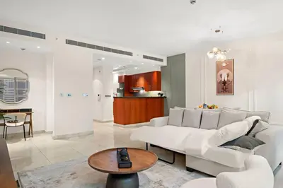 a living room with a white couch and a table at FIRST CLASS 1BR Luxury Living in DIFC in Dubai