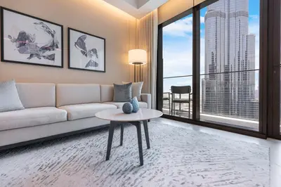 a living room with a couch and a table at Deluxe 3BR Home in Address Opera with Full Burj View in Dubai