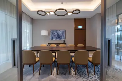 a dining room with a table and chairs at Deluxe 3BR Home in Address Opera with Full Burj View in Dubai
