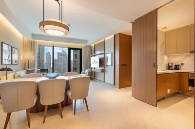 a kitchen and dining room with a table and chairs at Deluxe 3BR Home in Address Opera with Full Burj View in Dubai