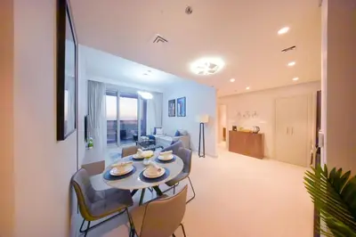 a living room with a table and a couch at PrimeForte Walk to Dubai Mall in Dubai