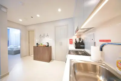a large kitchen with a sink and a stove at PrimeForte Walk to Dubai Mall in Dubai