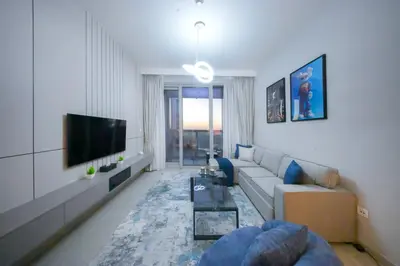 a living room with a couch and a tv at PrimeForte Walk to Dubai Mall in Dubai