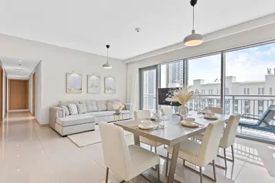a dining room and living room with a table and chairs at Luxurious Living 3 Bedroom at Harbour Views in Dubai