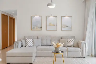 a living room with a couch and a table at Luxurious Living 3 Bedroom at Harbour Views in Dubai