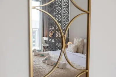 a bedroom with a mirror with a bed in it at Luxurious Living 3 Bedroom at Harbour Views in Dubai