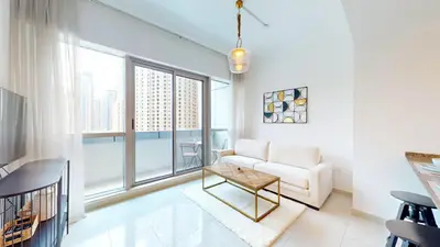 a living room with a couch and a table at Bay Central 2 - Charming One Bedroom in Dubai