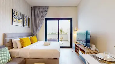 a hotel room with a bed and a couch at Azizi Riviera 46 - Cosy Studio in Dubai