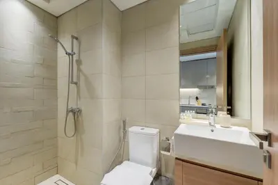 a bathroom with a shower and a toilet and a sink at Azizi Riviera 46 - Cosy Studio in Dubai