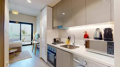 a kitchen with a sink and a counter top at Azizi Riviera 46 - Cosy Studio in Dubai
