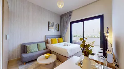 a hotel room with a bed and a chair at Azizi Riviera 46 - Cosy Studio in Dubai