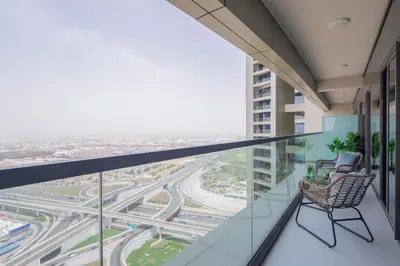 a balcony with two chairs and a view of a highway at Frank Porter - Aykon City Tower C in Dubai