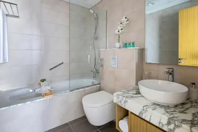 a bathroom with a sink and a toilet and a tub at Frank Porter - Aykon City Tower C in Dubai