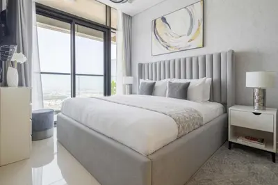 a bedroom with a large bed and a large window at Frank Porter - Aykon City Tower C in Dubai